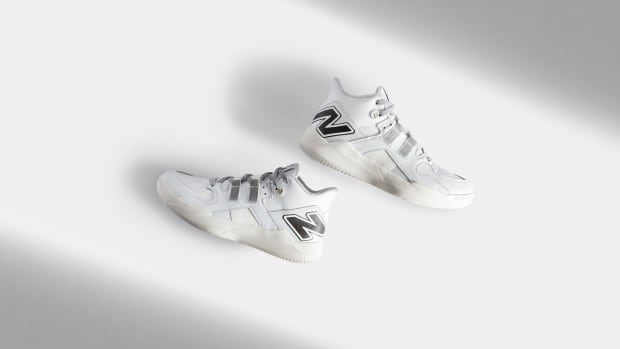 Side view of Coco Gauff's white and black New Balance tennis shoes.